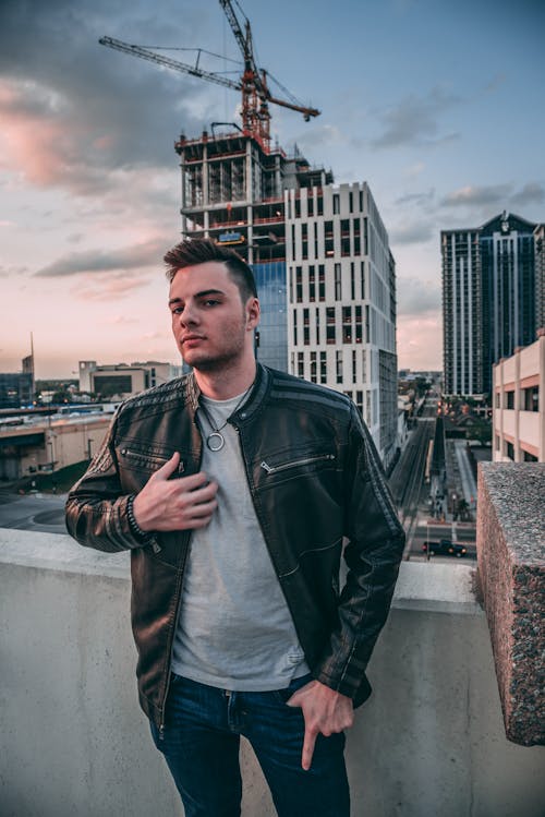 A Man in a Leather Jacket on the Rooftop