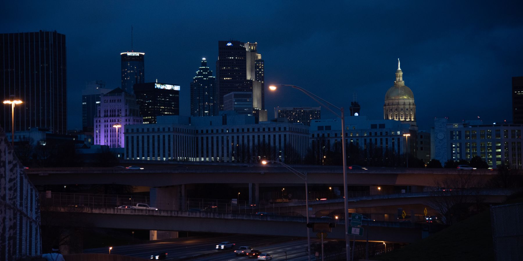 A captivating view of Atlanta's skyline with illuminated buildings and highways at night.