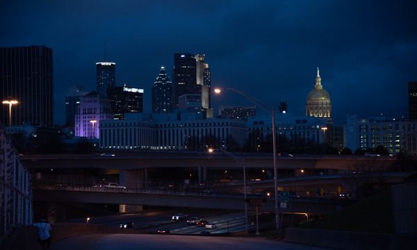 A captivating view of Atlanta's skyline with illuminated buildings and highways at night.