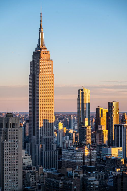 Free The Empire State Building at sunset, surrounded by Manhattan skyscrapers in New York City. Stock Photo