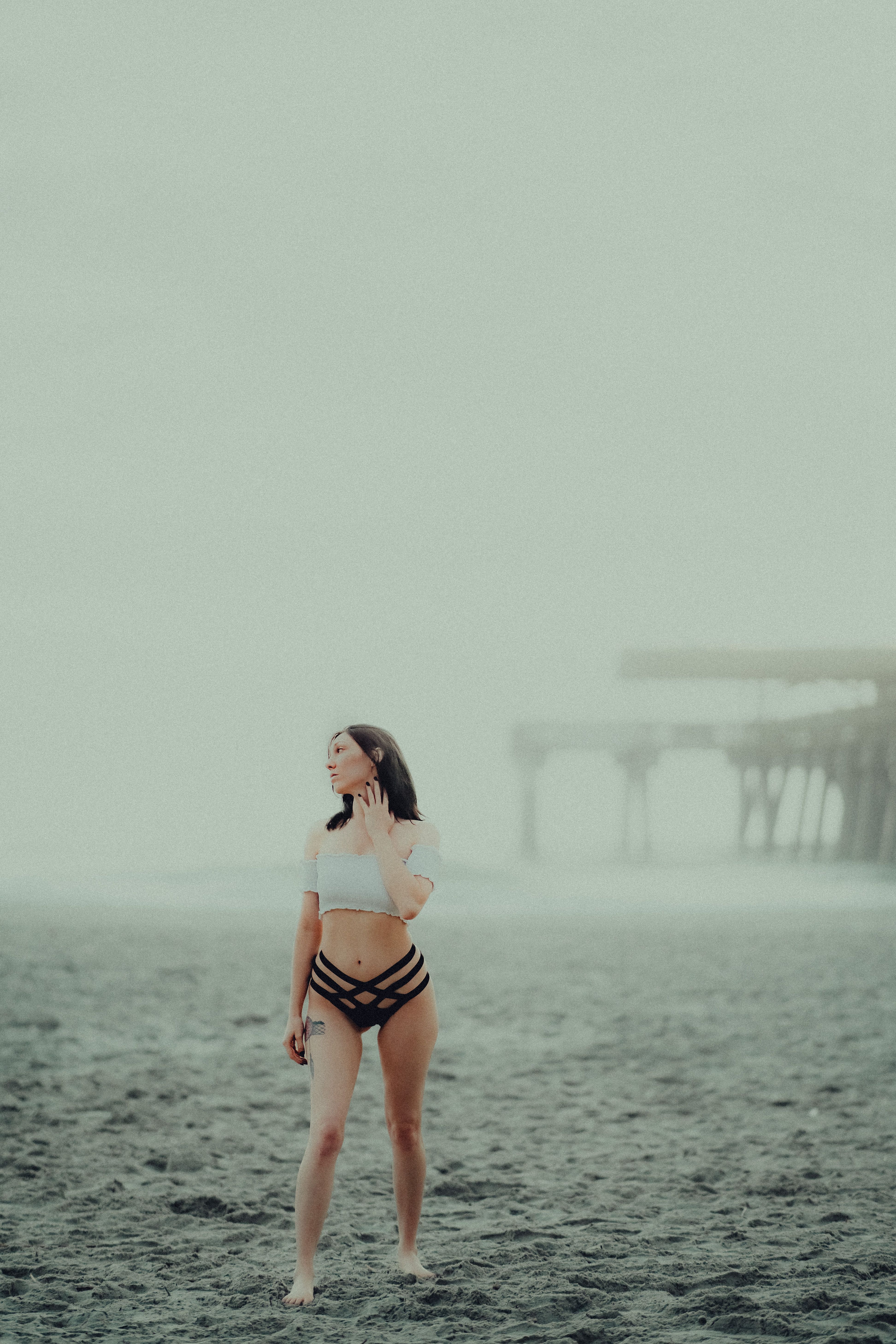 Woman in Black Bikini Standing on Beach Sand · Free Stock Photo
