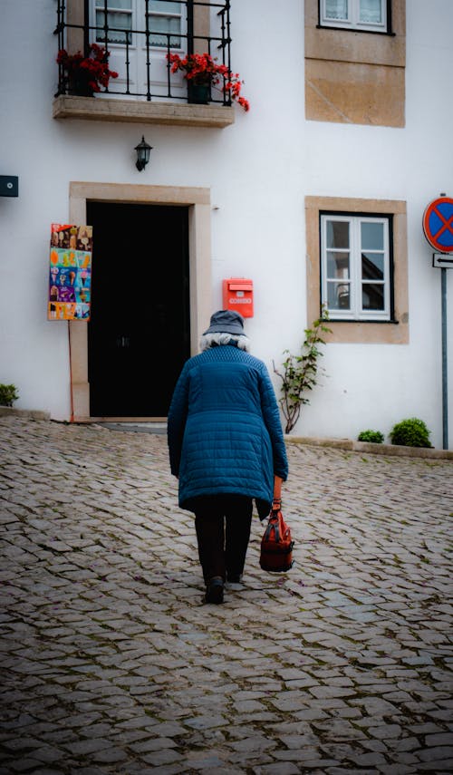 Back View of a Woman Walking toward the Entrance 