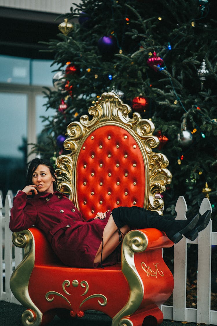 Fashion Woman Lying In Ornate Santa Claus Armchair