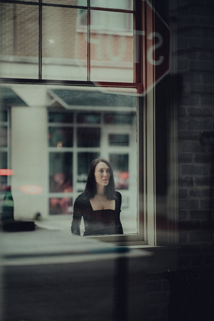 Woman On Street Reflection In Window