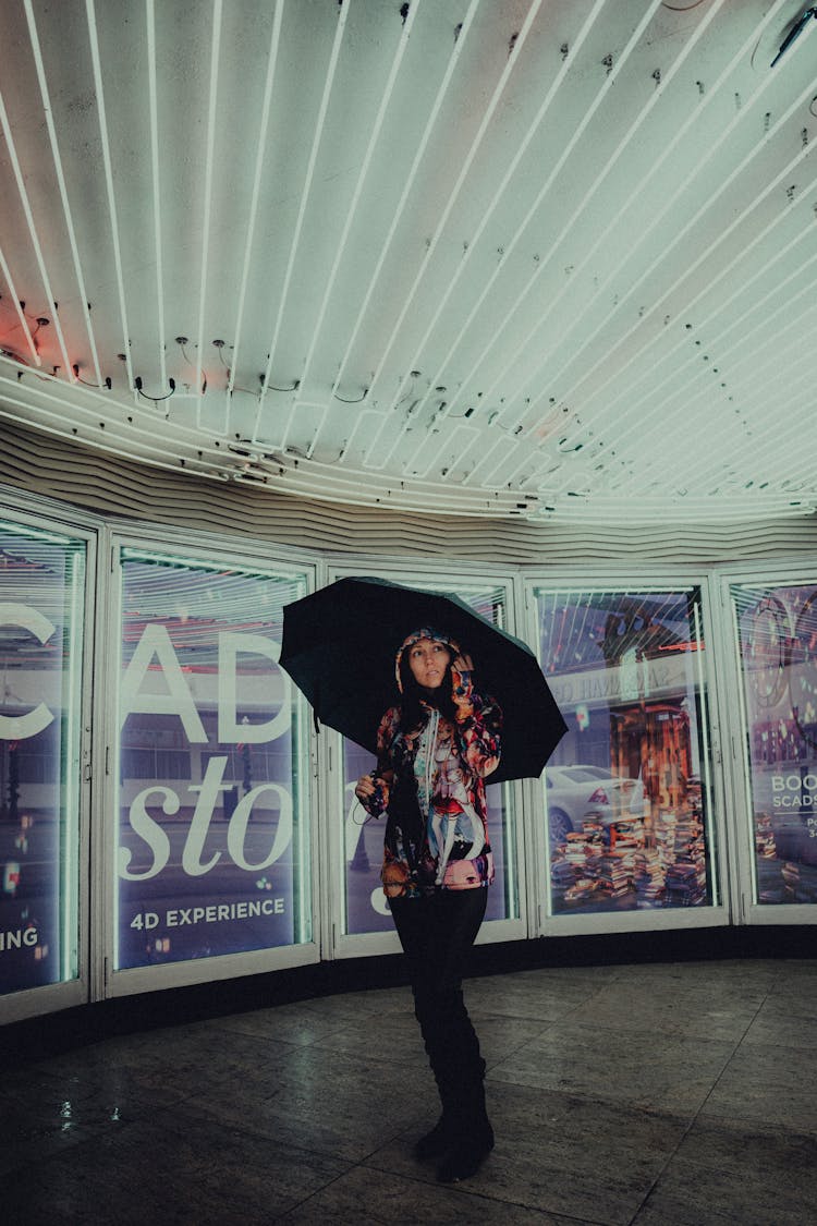 Woman With Umbrella While Shopping