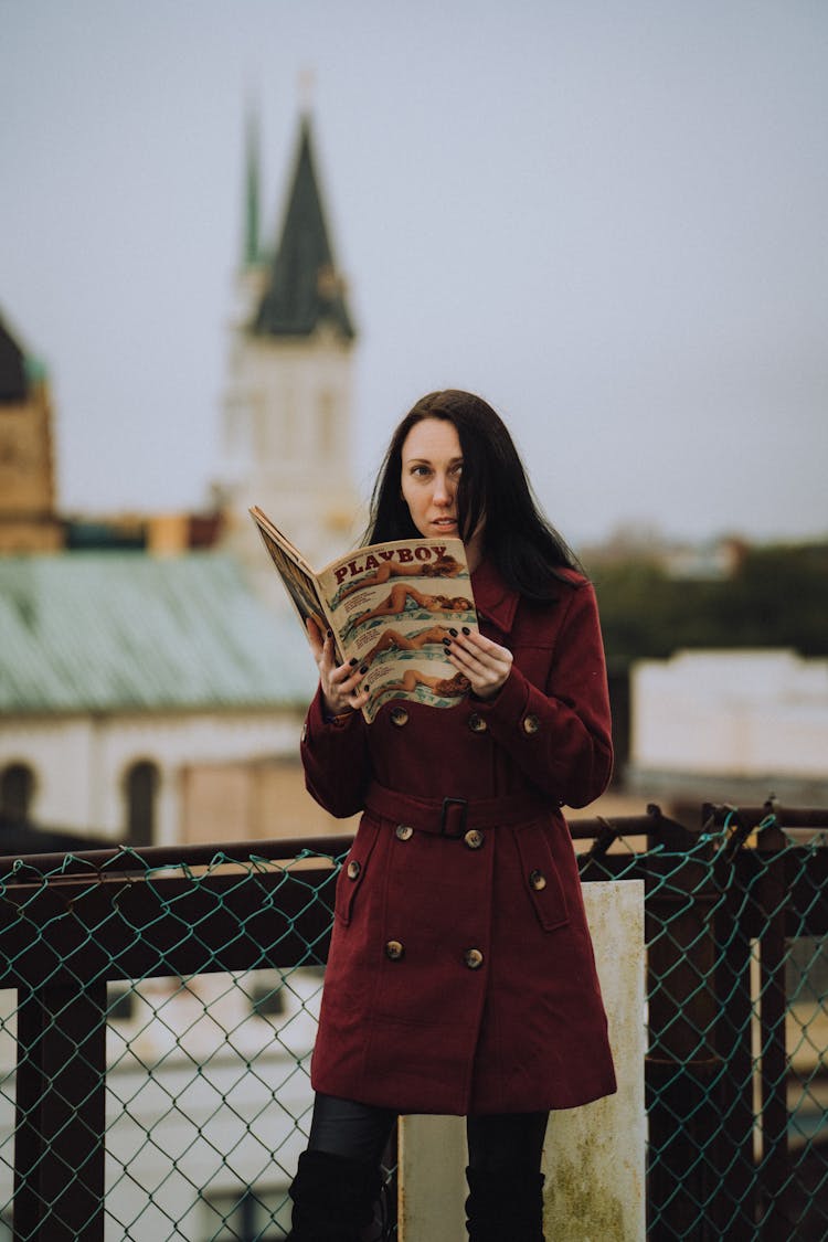 A Woman Holding A Magazine