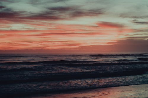 Ocean Waves Crashing on Shore During Sunset