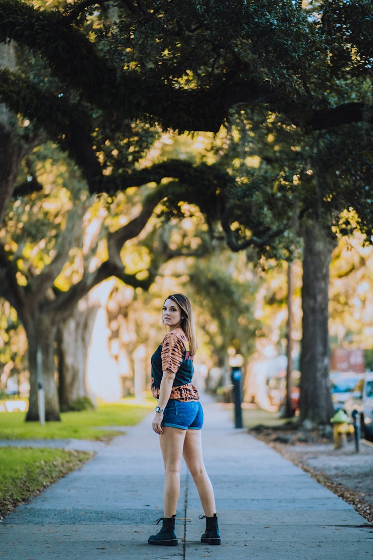 Blonde Woman In Jeans Shorts And Shirt