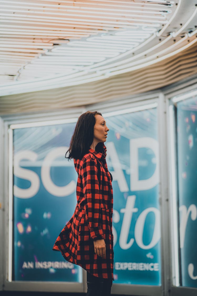 Portrait Of Woman Standing Sideways In Checked Shirt