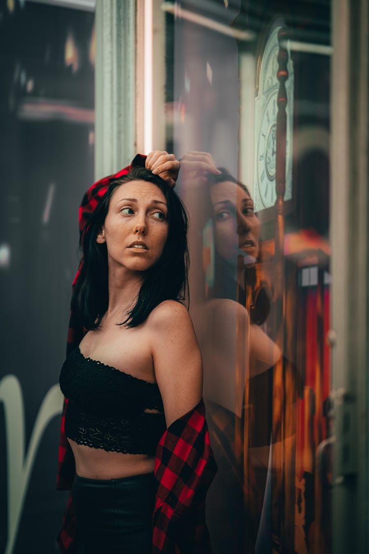 A Woman Standing By A Window