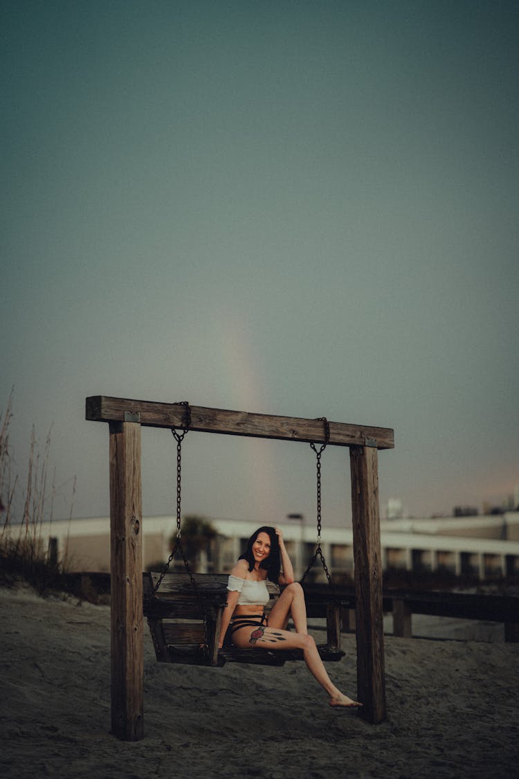 Woman Sitting On A Swing 