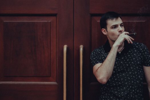 Man Smoking Cigar Standing by Door