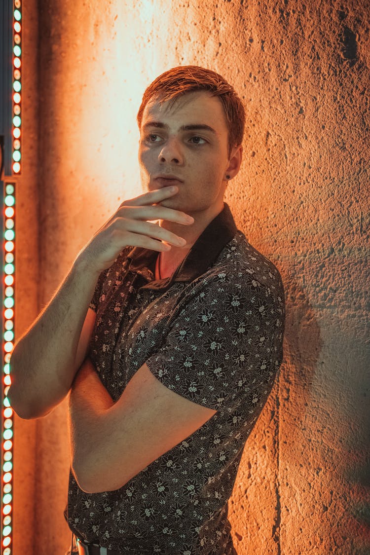 Man Standing Next To Wall Thinking