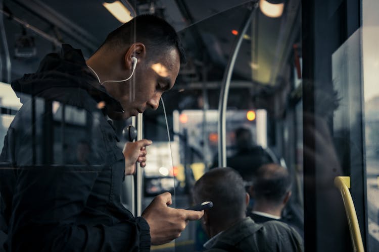 Man Listening To Music In Public Bus