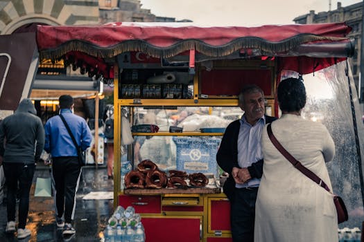 City scene with a street food vendor selling pretzels under a canopy, engaging with customers.
