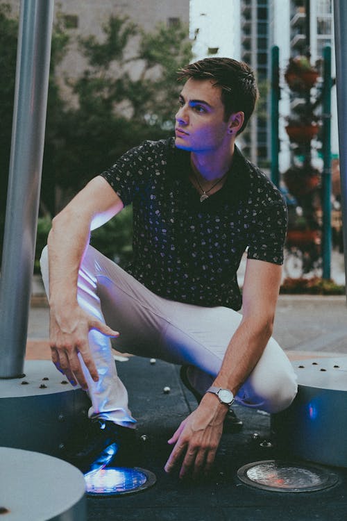 A man in Black Shirt and White Pants