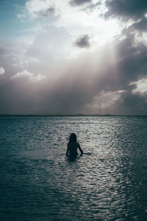 Silhouette of Woman in Water on Sunset · Free Stock Photo