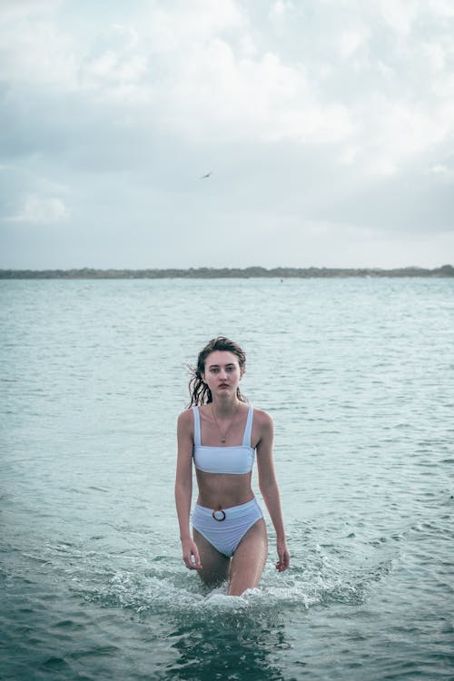 Woman in White Bikini Standing on the Beach