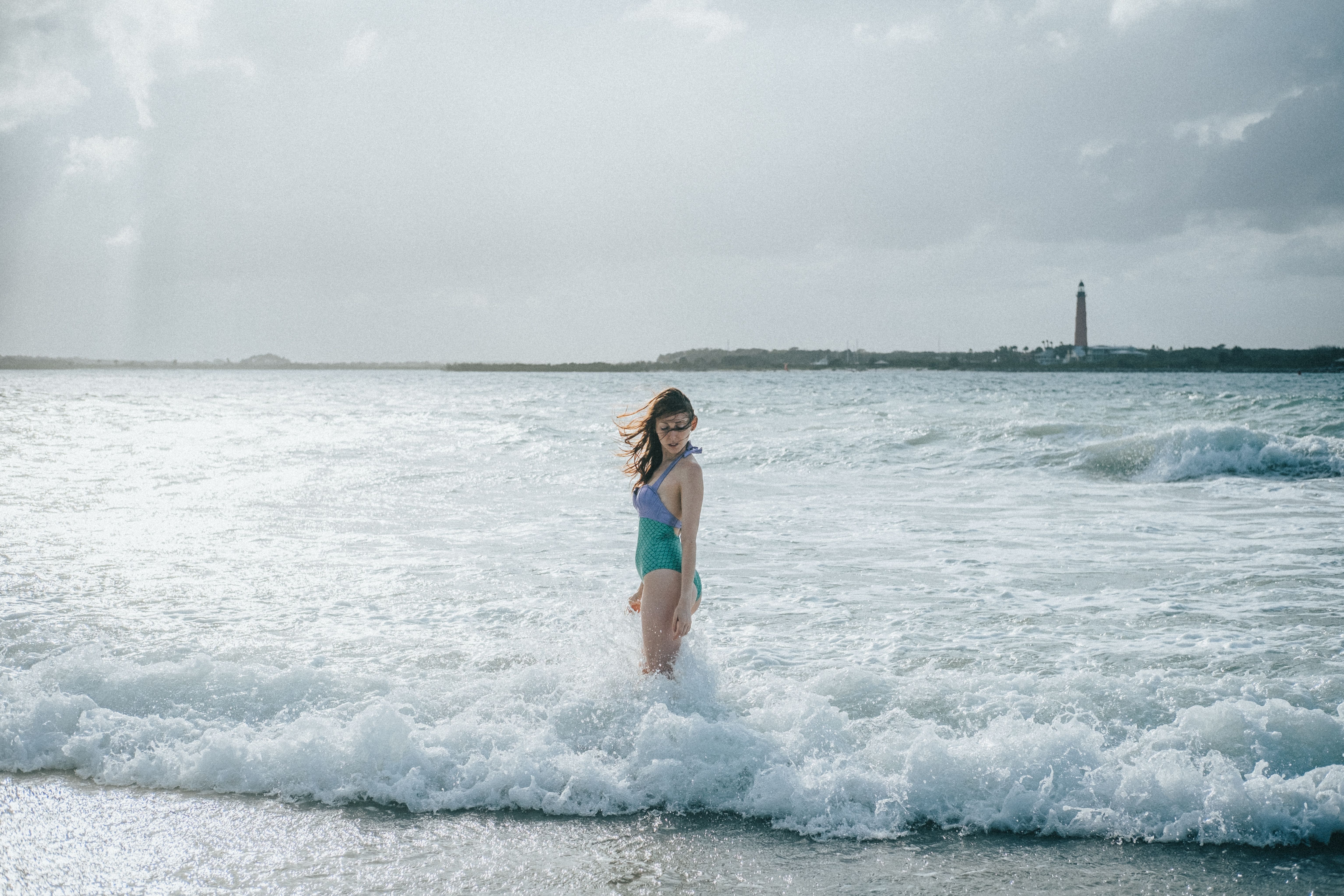 Woman in Purple and Green Bathing Suit Standing on the Beach · Free ...