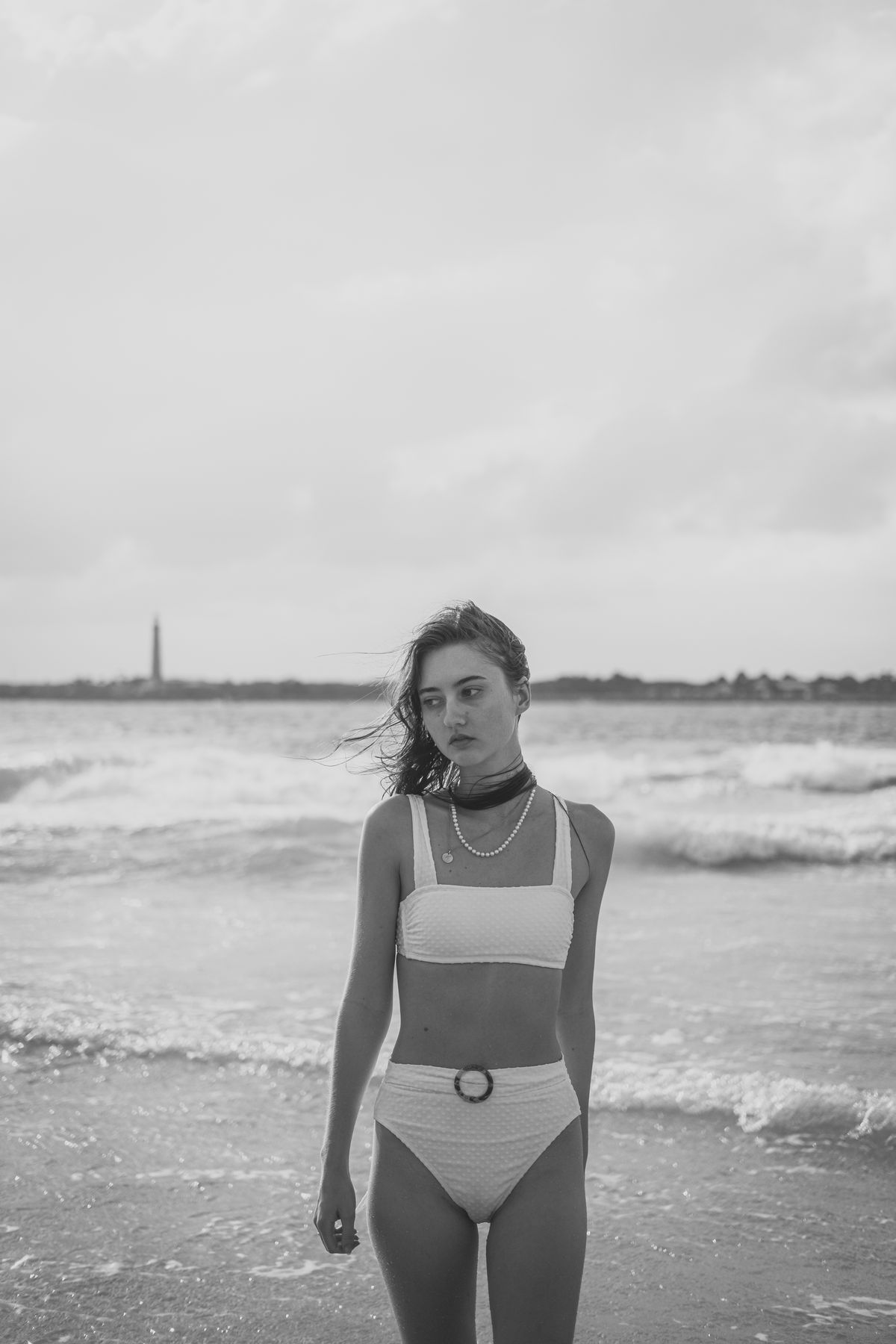 A woman standing on a beach — the considered ease of summer dressing