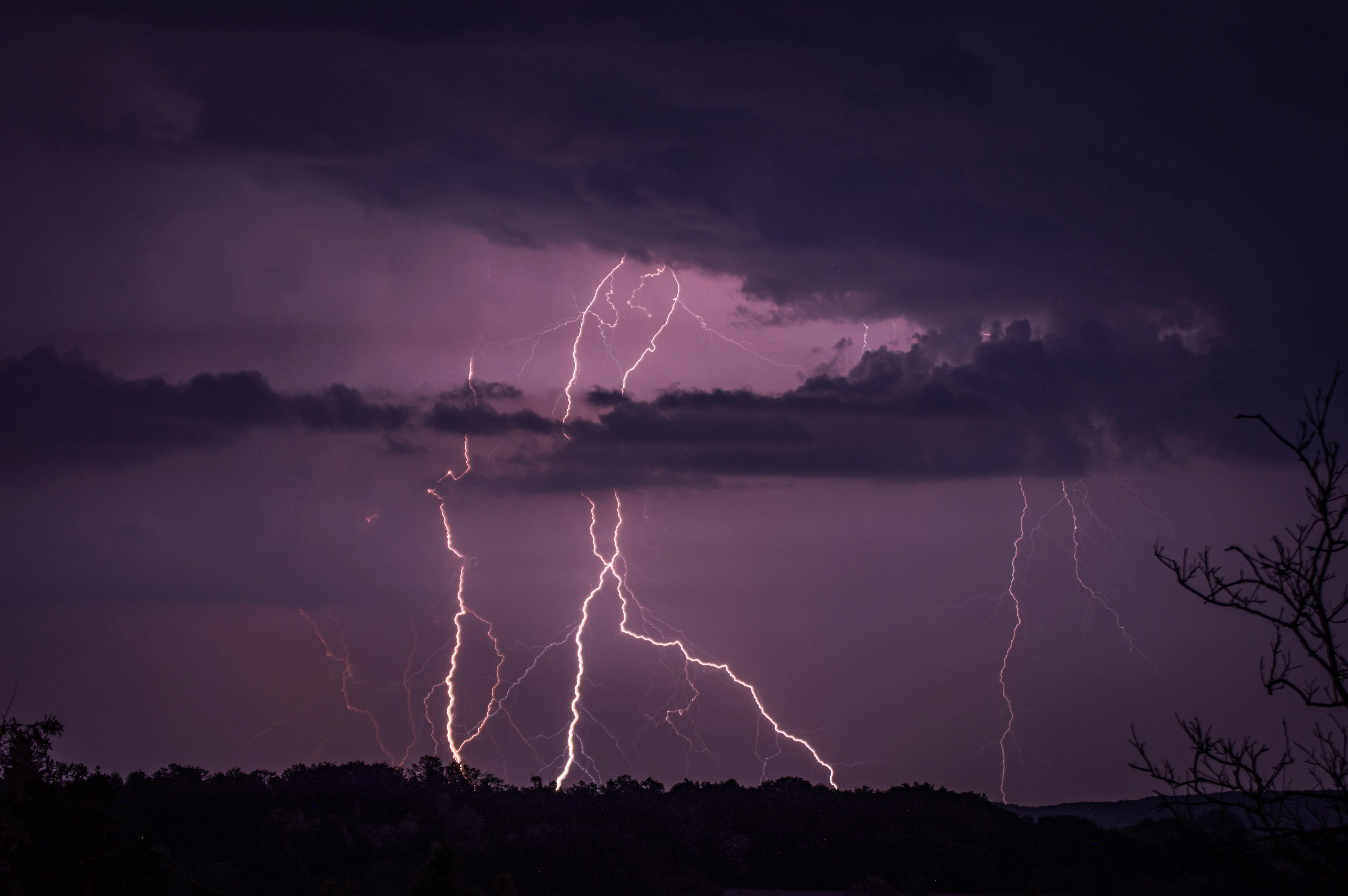 Stunning capture of lightning striking during a thunderstorm at twilight.