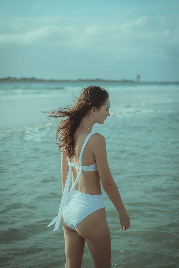 A Woman Wearing White Bikini On The Beach