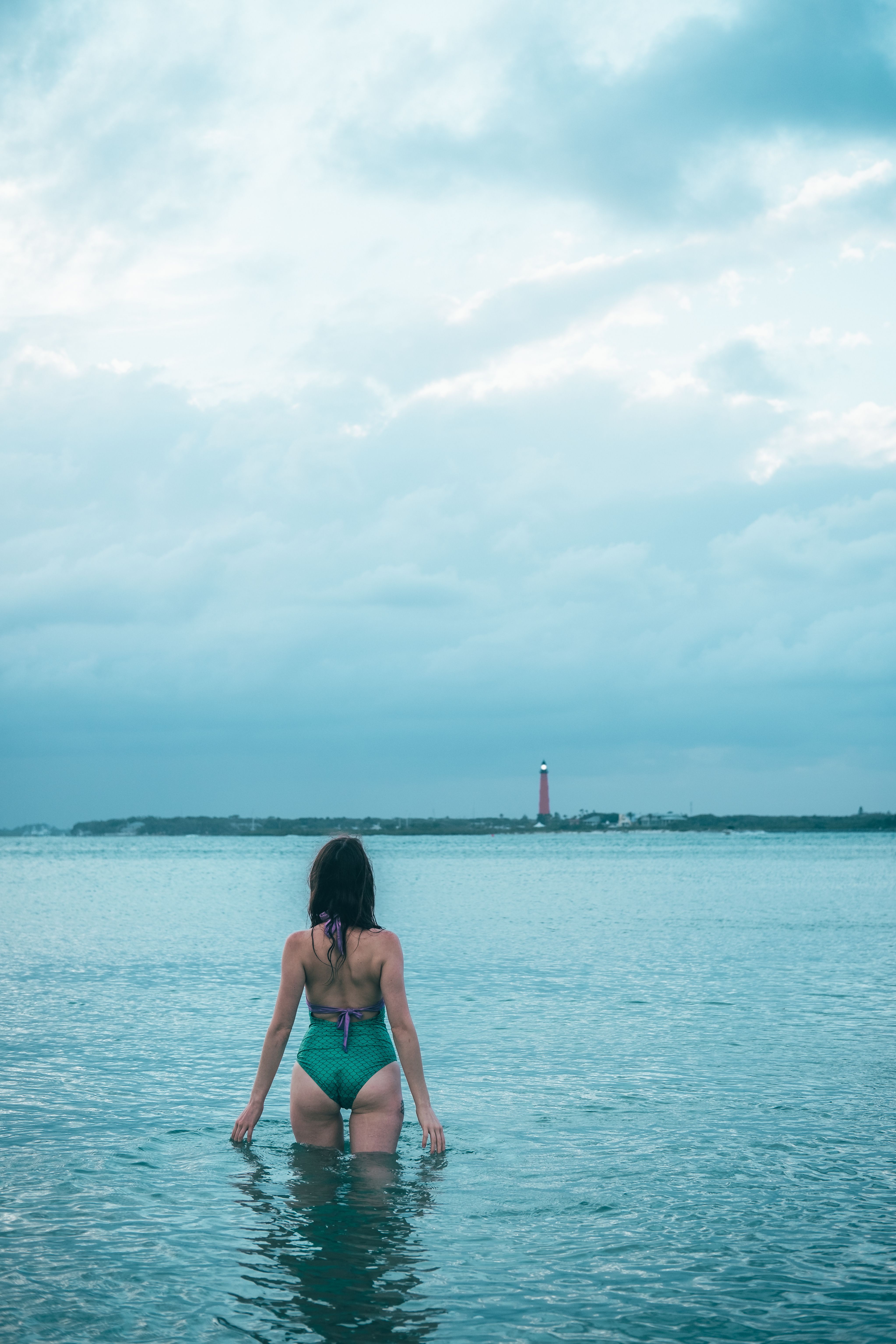 A Woman in Green Bikini Standing on the Beach · Free Stock Photo