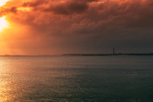 Body of Water Under Cloudy Sky