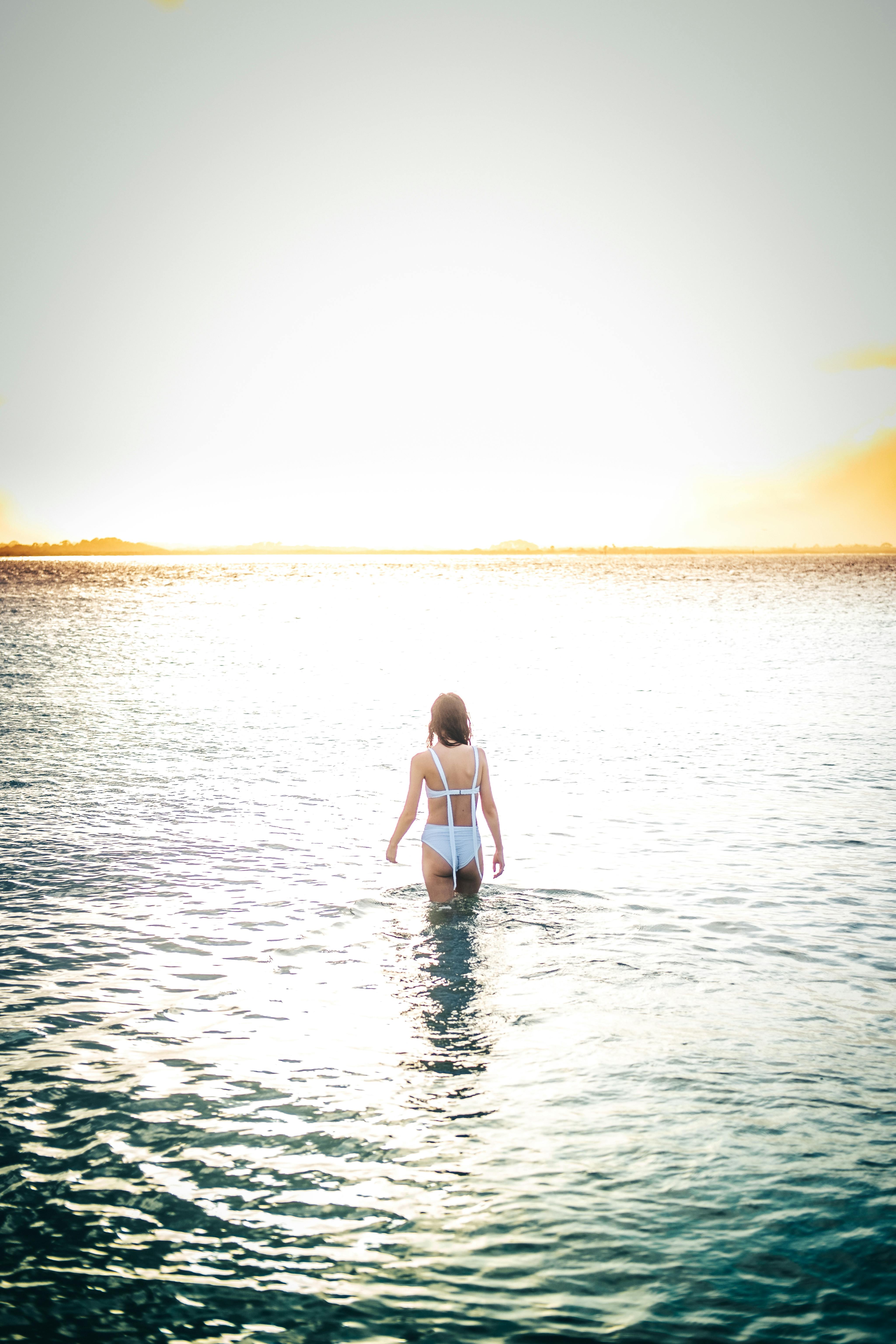 Premium Photo | Silhouette of woman standing at yoga pose on the tropical  beach during sunset. caucasian girl practicing yoga near sea water