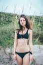 Woman in Black Bikini Standing on Sand with Grass