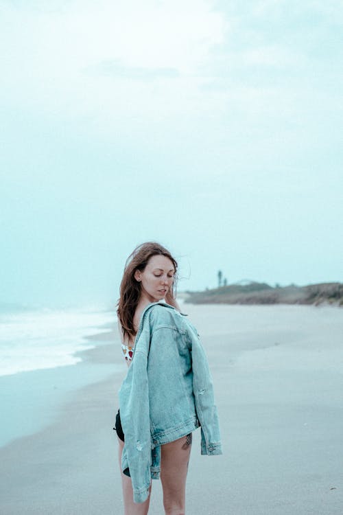 Free 
A Woman Standing on Beach Stock Photo