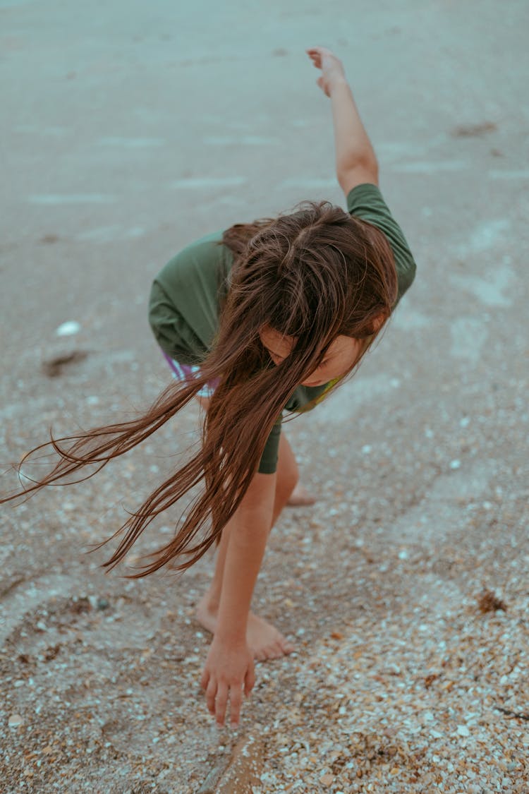 A Young Girl Playing On The Beach