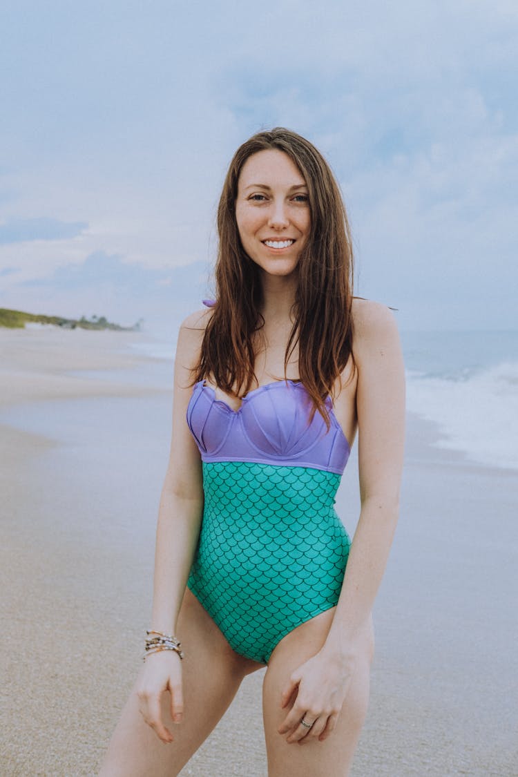 Woman In Mermaid Swimsuit Standing On Beach