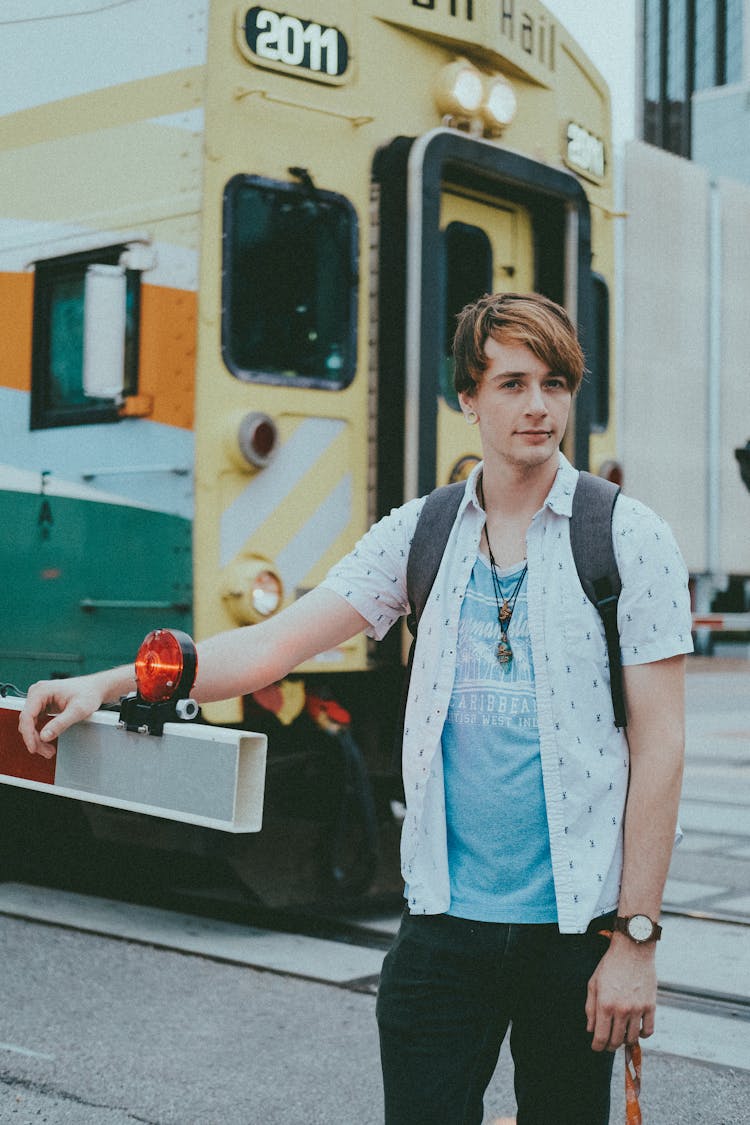 A Man Standing Near A Tram