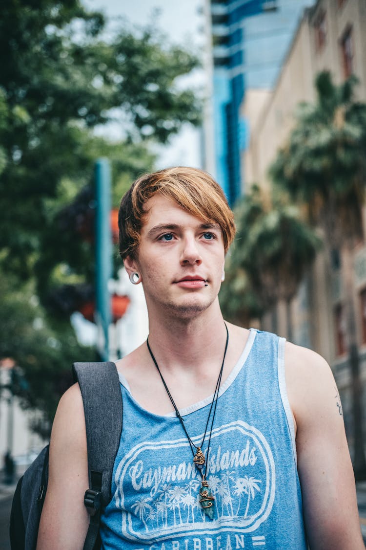 A Man In Blue Tank Top With Blonde Hair