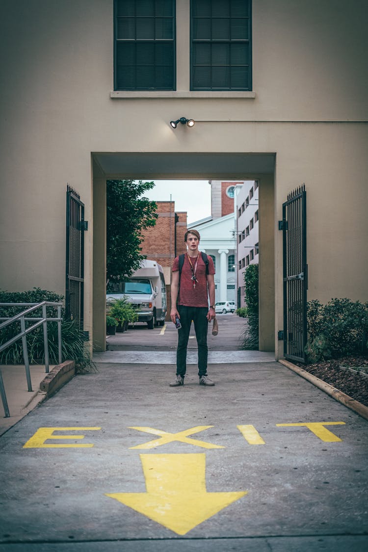 A Man Standing On A Driveway