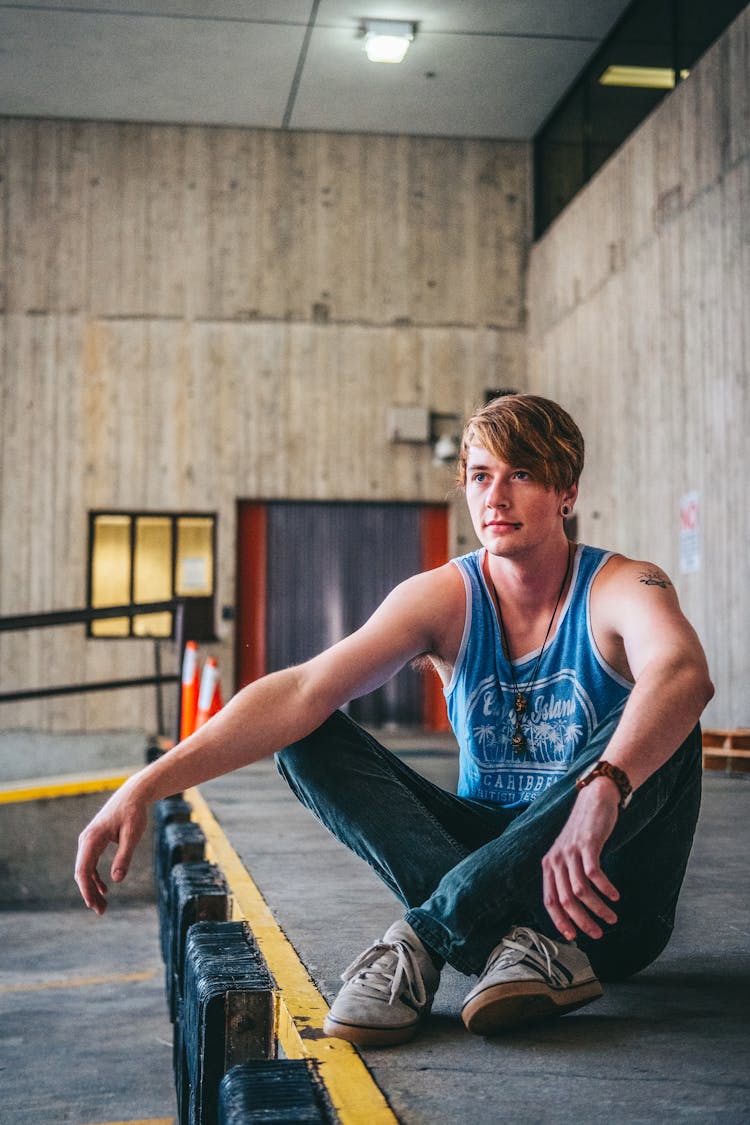 Man Siting In Warehouse