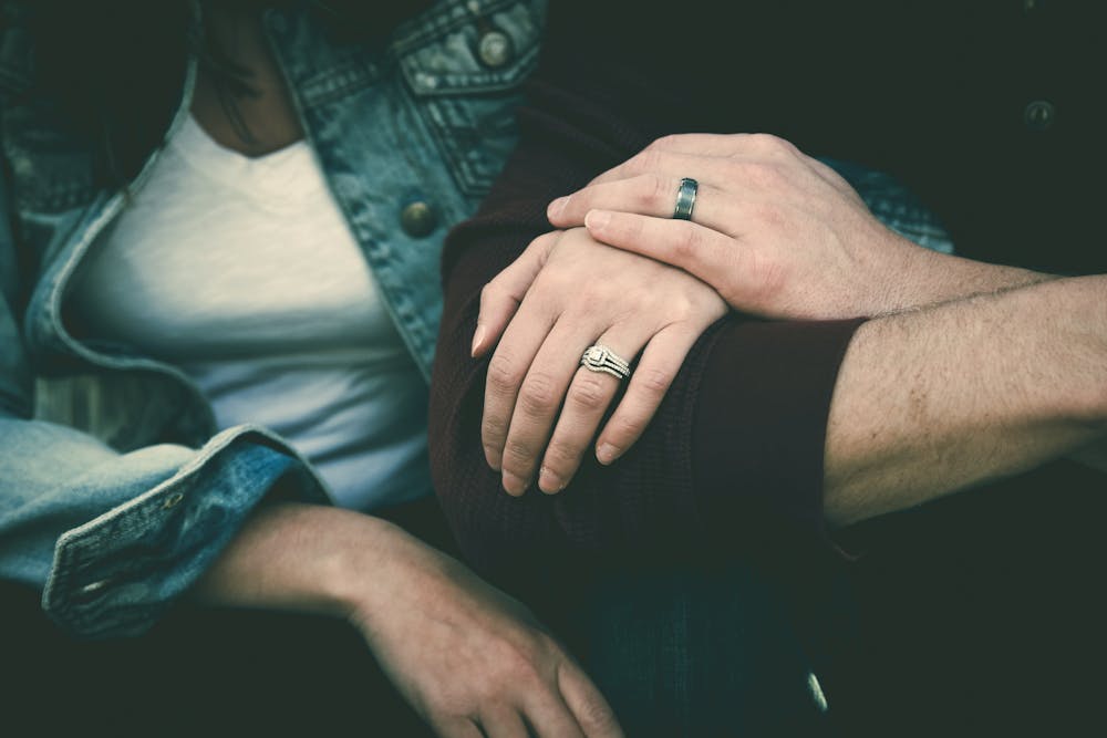 A woman holding the man's hand. | Photo: Pexels