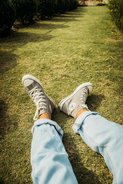 Free Person in Blue Denim Jeans and White Converse All Star High Top Sneakers Stock Photo