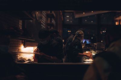 Cooks working a dim service line — photo by Yura Forrat on Pexels