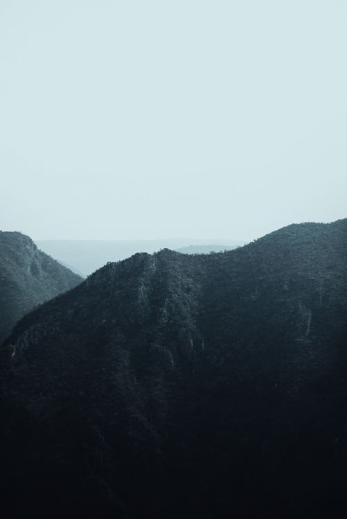 Free A tranquil mountain scene under a clear sky, offering a peaceful natural view. Stock Photo