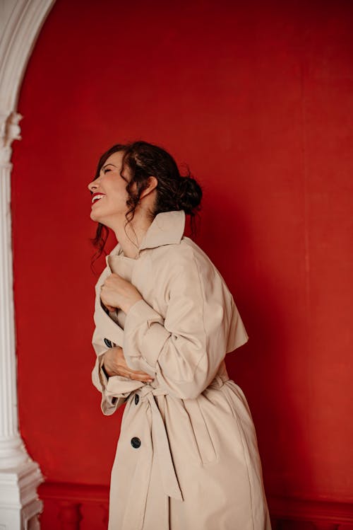 Portrait of Laughing Woman in Beige Coat