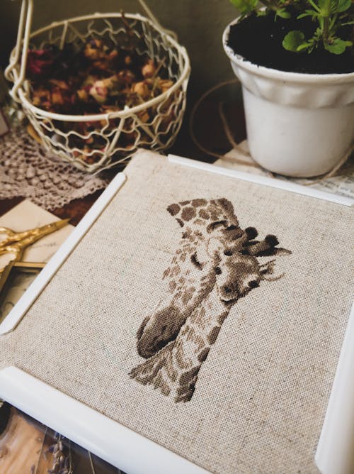 Free Close-up Shot of a Cross Stitch Project with Giraffe Design Stock Photo