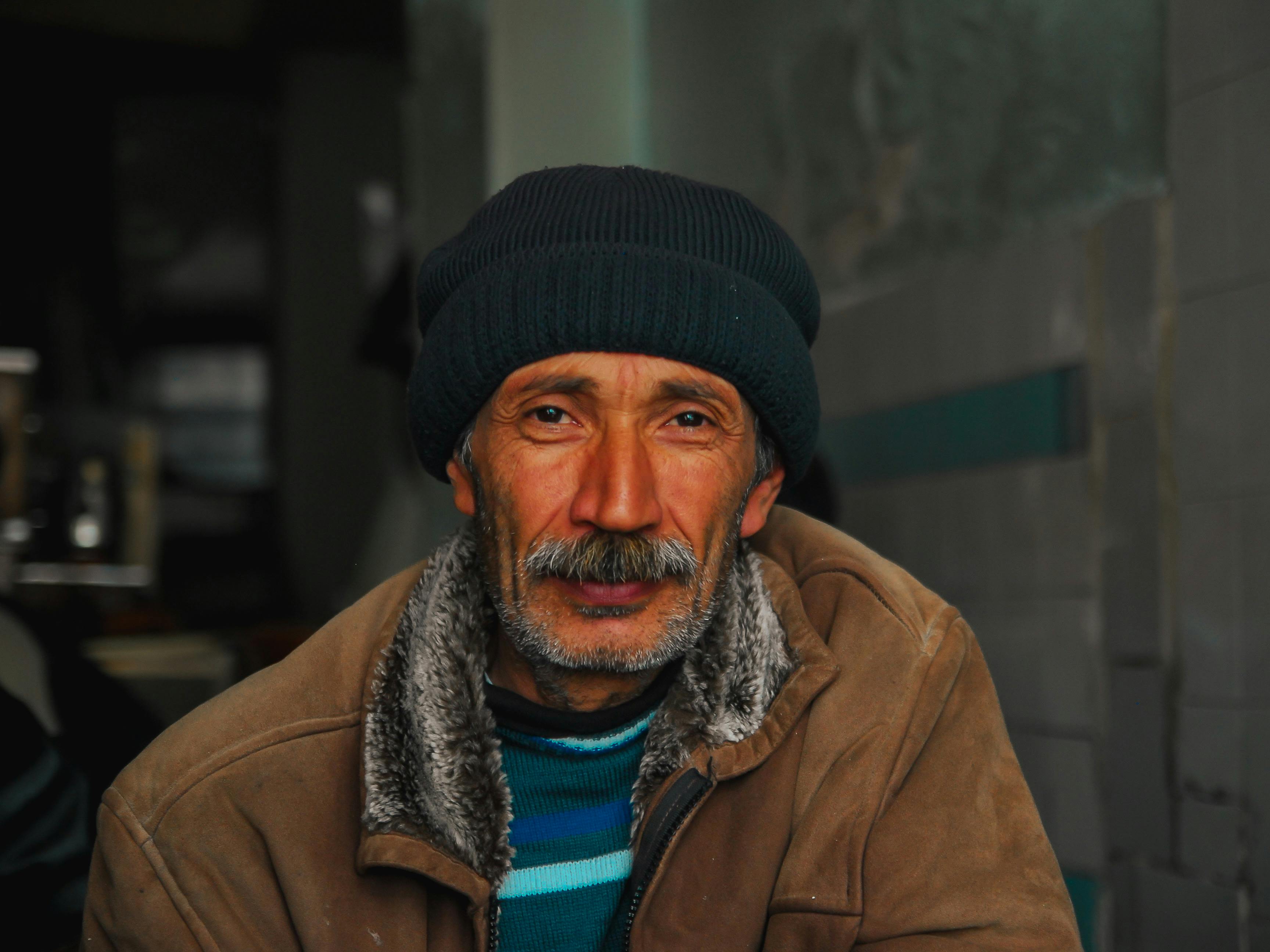 Middle age handsome man wearing a jacket Relaxing and stretching with arms  and hands behind head and neck, smiling happy Stock Photo - Alamy