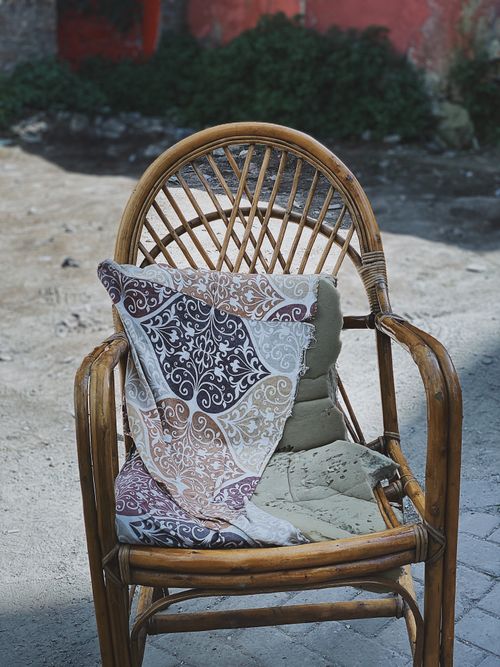 Free Outdoor vintage wooden chair with a torn cushion in Istanbul, Turkey. Stock Photo