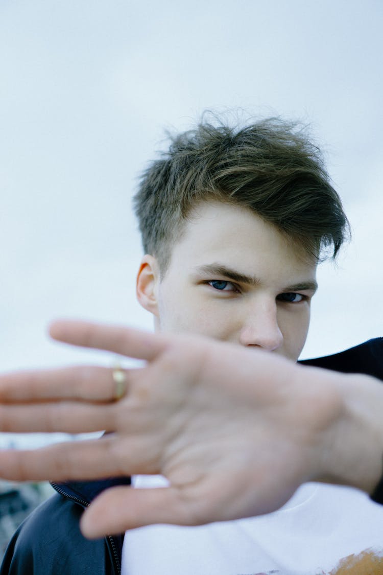 Man In Black Jacket Wearing A Gold Ring