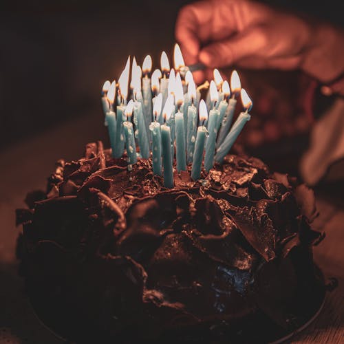 Free Lighted Candles on Chocolate Cake Stock Photo