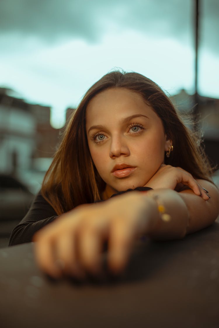 Portrait Of Woman Resting Head On Arm