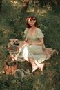 Woman in White Dress Sitting on Green Grass