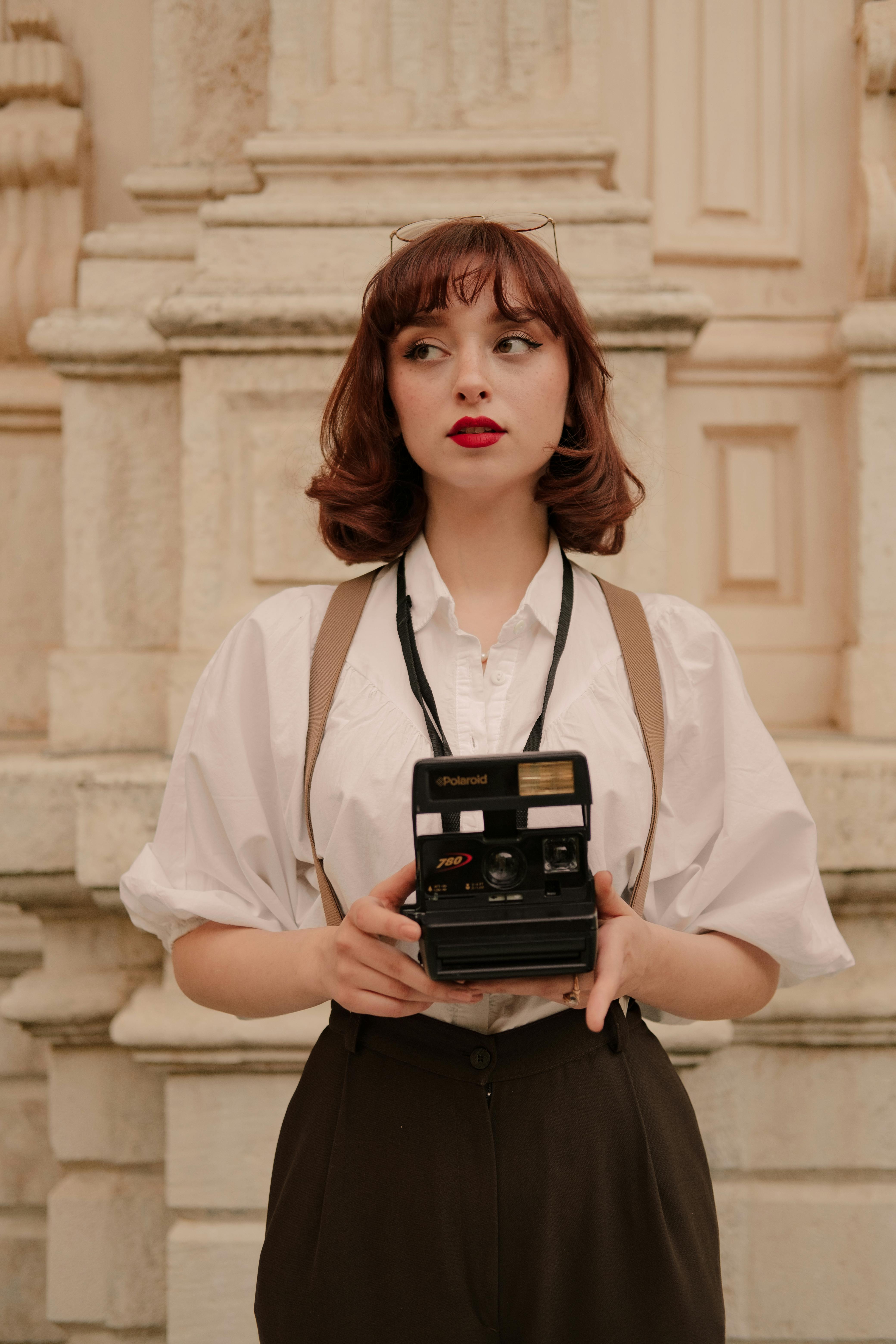 portrait of woman holding vintage camera